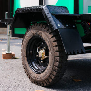 Heavy-duty transport wheels of mobile restroom unit