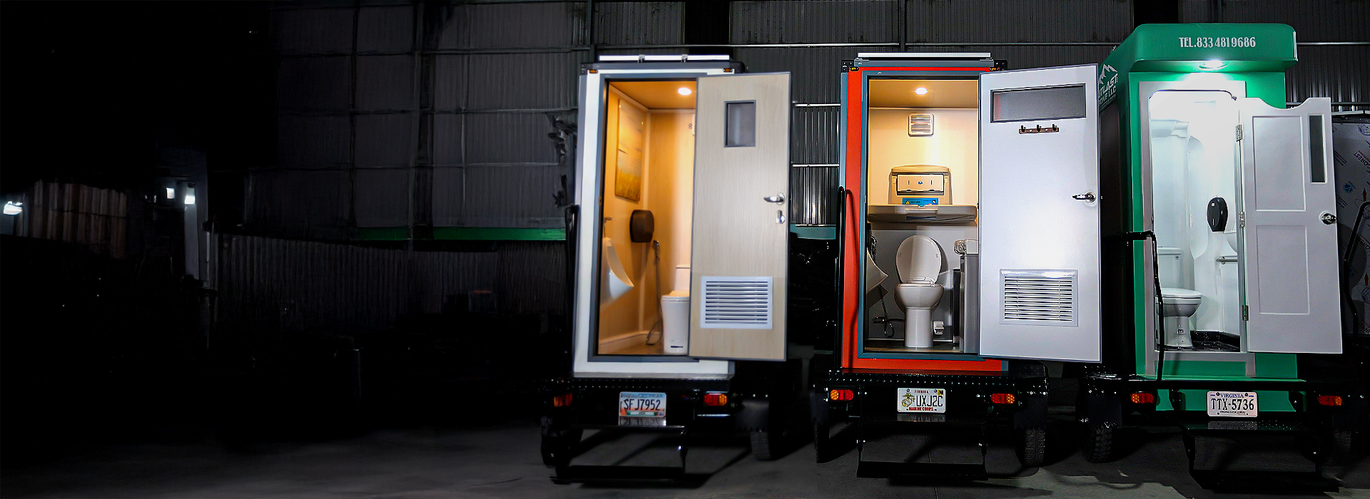 Mobile restroom trailers with open doors at night